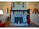 Stone fireplace with wooden mantle in the living room with decorations and vases at 1660 Almand Creek Sw Dr, Conyers, GA 30094