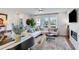 Sun-filled living room featuring a modern fireplace, hardwood floors, and an abundance of natural light at 1741 Lansmere Sw St, Marietta, GA 30008