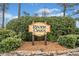 A decorative sign for the River Oaks community, surrounded by lush greenery and a stone base at 2323 River Station Ter, Woodstock, GA 30188