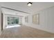 Finished basement with white walls, neutral floors, two shuttered windows and a glass sliding door at 355 Ridgeview Trl, Atlanta, GA 30328