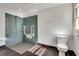 Accessible bathroom features a tiled walk-in shower with support bars and seat, plus a modern toilet at 355 Ridgeview Trl, Atlanta, GA 30328
