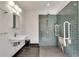 Accessible bathroom features a tiled walk-in shower with support bars and seat, plus a modern sink at 355 Ridgeview Trl, Atlanta, GA 30328