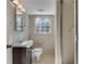 Small, tiled bathroom with a sink, mirror, toilet and shower behind a sliding glass door at 355 Ridgeview Trl, Atlanta, GA 30328