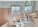 Tiled bathroom features a vintage sink, toilet and tub combination and a window with lots of light at 355 Ridgeview Trl, Atlanta, GA 30328