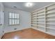 Bright bedroom with hardwood floors and large built-in bookshelf at 355 Ridgeview Trl, Atlanta, GA 30328