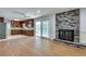Bright living room featuring a brick fireplace, hardwood floors, and sliding glass doors to screened in porch at 355 Ridgeview Trl, Atlanta, GA 30328