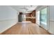 Spacious living room with hardwood floors, access to a screened-in porch, and an adjacent kitchen area at 355 Ridgeview Trl, Atlanta, GA 30328