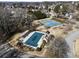 This aerial view features a pool, tennis courts, and playground in a residential community at 1471 Adair Hill Ct, Dacula, GA 30019