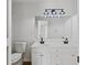 A bathroom with a double sink vanity, dark fixtures, and a large mirror at 1471 Adair Hill Ct, Dacula, GA 30019