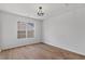 This bright bedroom offers hardwood floors and a modern light fixture at 1471 Adair Hill Ct, Dacula, GA 30019