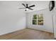 This bedroom has hardwood floors, ceiling fan, and a large window at 1471 Adair Hill Ct, Dacula, GA 30019