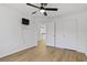 Hardwood bedroom featuring a ceiling fan, closet, and TV at 1471 Adair Hill Ct, Dacula, GA 30019