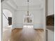 Dining room featuring hardwood floors and bright white trim, flowing into the living spaces with the entry visible beyond at 1471 Adair Hill Ct, Dacula, GA 30019