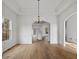 Elegant dining room boasting tray ceilings, hardwood floors and modern light fixtures at 1471 Adair Hill Ct, Dacula, GA 30019