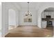 Bright dining room features tray ceilings, modern chandelier, large window, and access to the kitchen with stainless appliances at 1471 Adair Hill Ct, Dacula, GA 30019