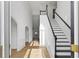 Bright foyer with hardwood floors and elegant staircase creating an inviting atmosphere at 1471 Adair Hill Ct, Dacula, GA 30019
