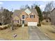 A charming brick-front home with a well-manicured lawn and attached two-car garage at 1471 Adair Hill Ct, Dacula, GA 30019