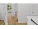 Hallway leading to a bedroom, showing doors, wood floors, and white trim at 1471 Adair Hill Ct, Dacula, GA 30019