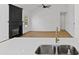 Close-up of a quartz kitchen island with stainless steel appliances and black fireplace visible at 1471 Adair Hill Ct, Dacula, GA 30019