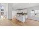 Open-concept kitchen featuring a large island, stainless appliances, and white cabinets with decorative back splash at 1471 Adair Hill Ct, Dacula, GA 30019