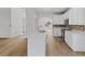 Bright kitchen with white cabinets, stainless steel appliances, and a large island with quartz countertop and sink at 1471 Adair Hill Ct, Dacula, GA 30019