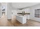 Open concept kitchen with a large island, white cabinets, stainless steel appliances, and decorative backsplash at 1471 Adair Hill Ct, Dacula, GA 30019