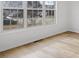Bright living room featuring large windows, flooding the room with natural light and hardwood floors at 1471 Adair Hill Ct, Dacula, GA 30019