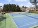 A view of community tennis courts with lush landscaping at 1471 Adair Hill Ct, Dacula, GA 30019