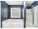 Bathroom featuring a soaking tub and a separate shower at 939 Mill Creek Ave, Canton, GA 30115