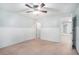 Bedroom with a light fixture, carpet, white paneled walls and doors to other rooms at 939 Mill Creek Ave, Canton, GA 30115