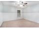 Bedroom featuring a ceiling fan, large window and white paneled walls at 939 Mill Creek Ave, Canton, GA 30115