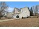 Home showcasing clean white siding, well-maintained greenery, a fenced yard, and a spacious two-car garage at 939 Mill Creek Ave, Canton, GA 30115