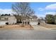 Suburban two-story home with beige siding, a two-car garage, well-manicured lawn, and mature trees in a Gathering-friendly neighborhood at 939 Mill Creek Ave, Canton, GA 30115