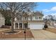 Charming two-story home featuring stone accents, neutral siding, a two-car garage, and a well-maintained front yard at 939 Mill Creek Ave, Canton, GA 30115