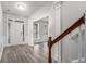 Bright foyer with wood-look flooring, white trim, staircase and views into adjoining rooms at 939 Mill Creek Ave, Canton, GA 30115