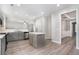 Modern kitchen with grey cabinets, island, stainless steel appliances, and open layout at 939 Mill Creek Ave, Canton, GA 30115