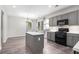 Modern kitchen with grey cabinets, island, stainless steel appliances, and eat-in area at 939 Mill Creek Ave, Canton, GA 30115
