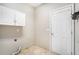 Utility room with cabinets, utility sink and tile flooring at 939 Mill Creek Ave, Canton, GA 30115