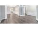 Spacious living area featuring wood floors, gray paint, white trim, and an open doorway at 939 Mill Creek Ave, Canton, GA 30115