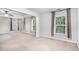 Bright main bedroom with neutral walls, a ceiling fan, and two large windows at 939 Mill Creek Ave, Canton, GA 30115
