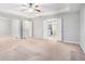 Spacious main bedroom featuring a ceiling fan, neutral walls, and a private ensuite bathroom at 939 Mill Creek Ave, Canton, GA 30115