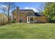 Charming home showcasing a spacious yard, mature trees, and attractive landscaping at 1655 Pine Ridge Cir, Woodstock, GA 30188