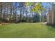Lush green backyard featuring mature trees, a private setting, and well-maintained landscaping at 1655 Pine Ridge Cir, Woodstock, GA 30188