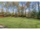 Expansive backyard featuring lush greenery, mature trees, and meticulously manicured landscaping at 1655 Pine Ridge Cir, Woodstock, GA 30188