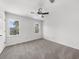 Bright bedroom featuring plush carpet, a ceiling fan, and natural light from two windows at 1655 Pine Ridge Cir, Woodstock, GA 30188