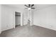 Spacious bedroom with ceiling fan, large closet, and carpeted floor at 1655 Pine Ridge Cir, Woodstock, GA 30188