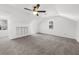 Bright, vaulted bedroom with modern ceiling fan, neutral decor, and built-in shelves at 1655 Pine Ridge Cir, Woodstock, GA 30188