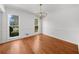 Dining room features hardwood floors, a chandelier, and natural light from large windows at 1655 Pine Ridge Cir, Woodstock, GA 30188