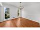 Bright dining room with hardwood floors, modern chandelier, and natural light at 1655 Pine Ridge Cir, Woodstock, GA 30188