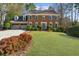 Charming brick two-story home featuring a well-manicured lawn and attached two-car garage at 1655 Pine Ridge Cir, Woodstock, GA 30188
